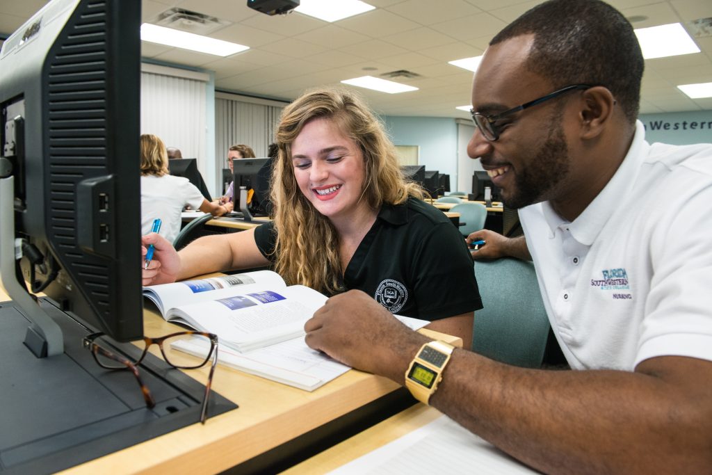 FSW Student and instructor working together at a computer.