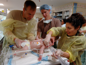 Three medical professionals trying to save an infant who was shaken.