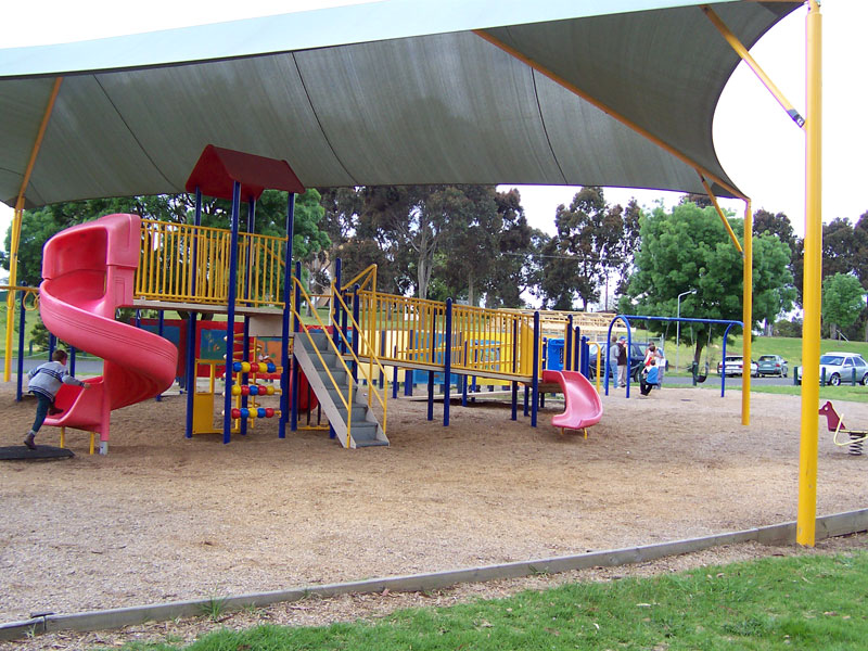 This playground protects children from falls and from the sun.  But it fails to protect children by being enclosed with a fence and gate.