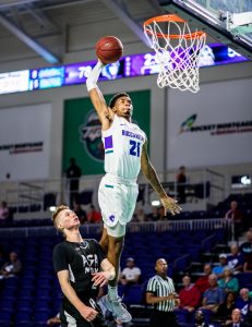 Photo of FSW Basketball player dunking a ball.